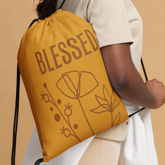 Mustard-color drawstring bag with BLESSED text and monoline flowers