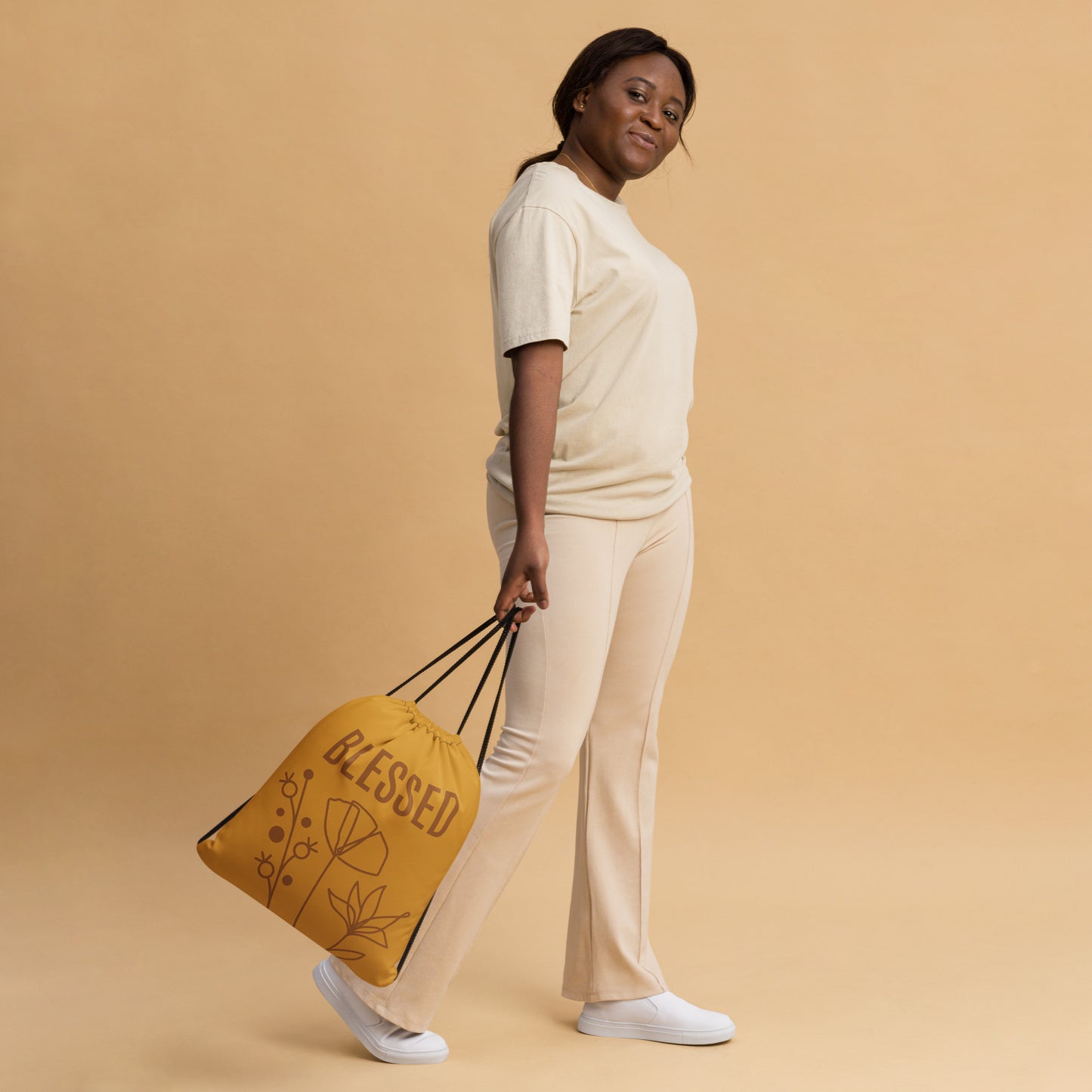 Yellow drawstring bag with BLESSED text and monoline flowers