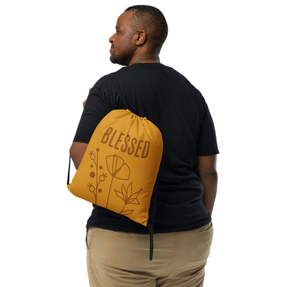 Mustard-color drawstring bag with BLESSED text and monoline flowers