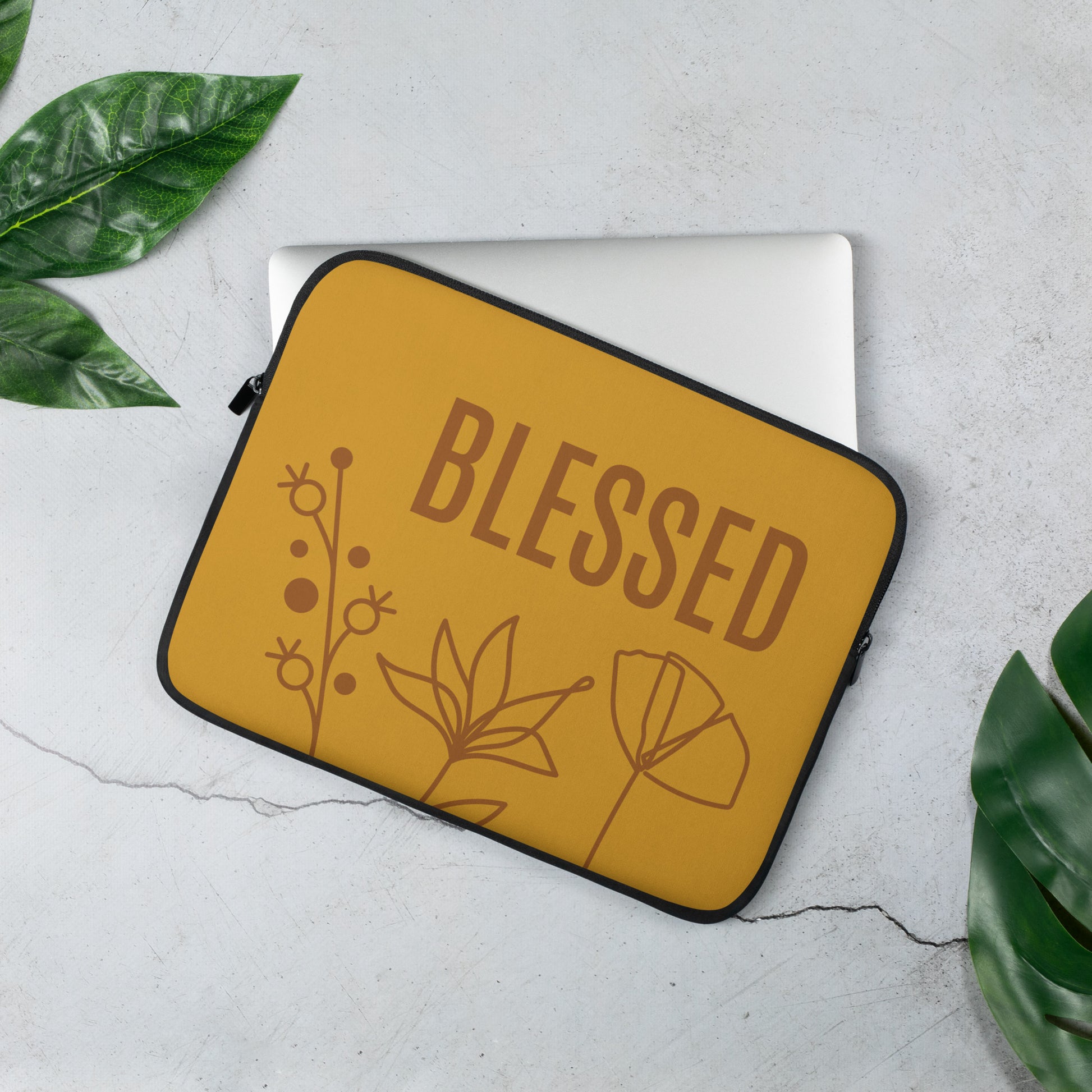 Yellow laptop sleeve, with BLESSED text, and flower monoline design