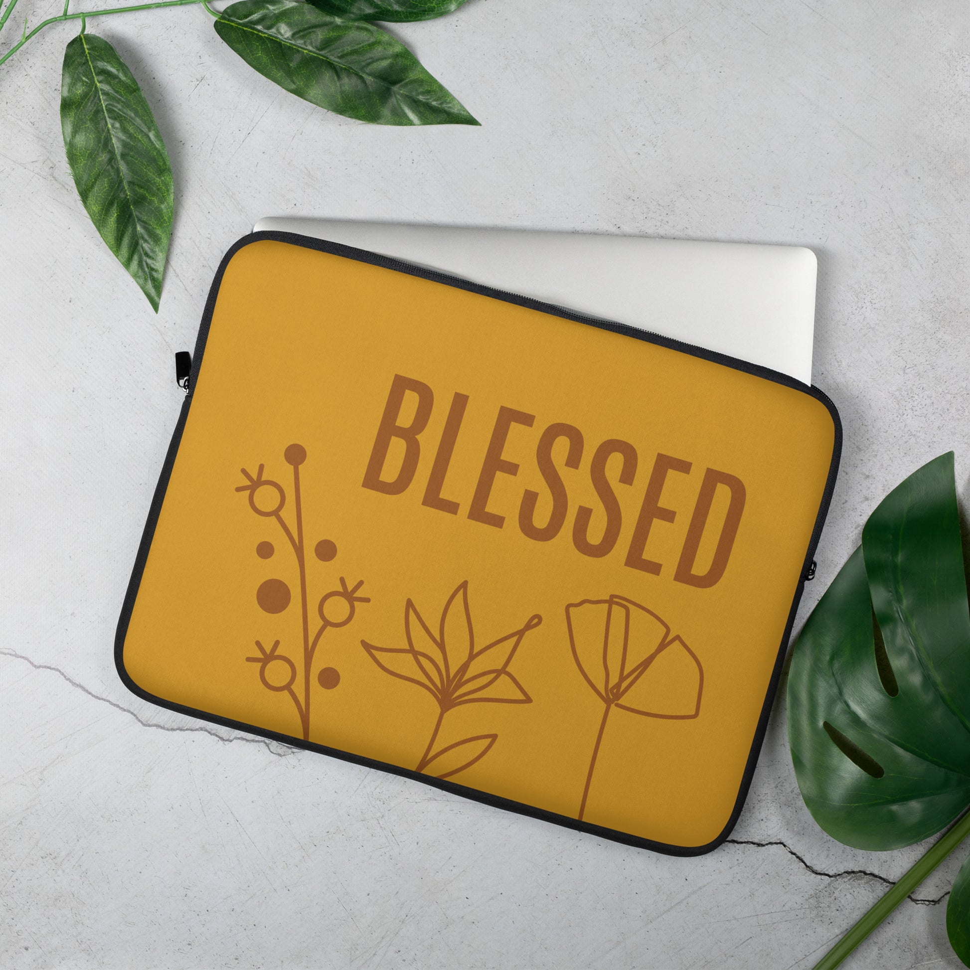 Mustard laptop sleeve, with BLESSED text, and flower monoline design